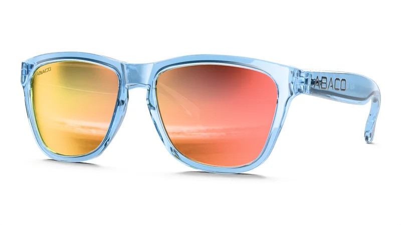 3D render of the same light blue translucent sunglasses with orange-to-pink mirror lenses, three-quarter view